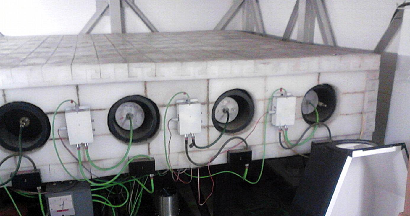 Close view of cylindrical counter tube ends and green wiring against white polyethylene blocks.